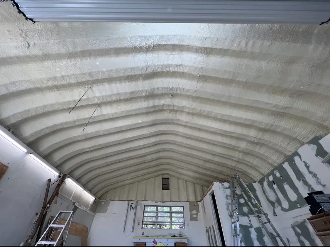 Spray polyurethane foam applied to the underside of a metal roof deck in Harrietstown